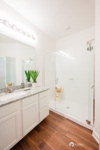 A white bathroom with a glass shower stall is featured in some of the modern apartments in Ocala.