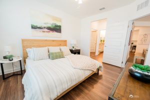 An apartment in Ocala featuring a bedroom with hardwood floors and a painting on the wall.