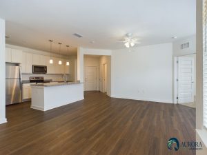 Apartments for rent in Ocala Spacious modern kitchen with stainless steel appliances and open-plan living area with hardwood floors in apartments for rent in Ocala. Aurora St. Leon Apartments in Ocala 2150 NW 21st Avenue | Ocala, FL 34475 (352) 233-4133