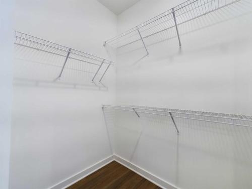 Apartments for rent in Ocala Empty white closet with wire shelving on three walls and a wooden floor. Aurora St. Leon Apartments in Ocala 2150 NW 21st Avenue | Ocala, FL 34475 (352) 233-4133