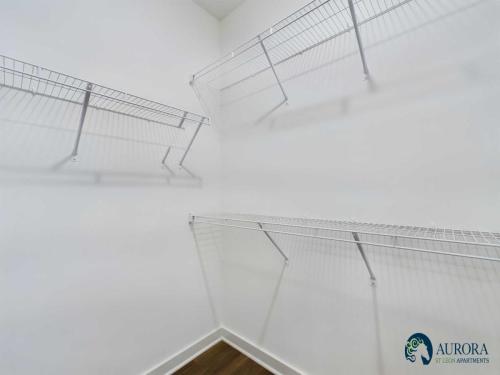 Apartments for rent in Ocala An empty white closet with wire shelving units on two walls. The logo Aurora Silton Apartments is in the bottom right corner. Aurora St. Leon Apartments in Ocala 2150 NW 21st Avenue | Ocala, FL 34475 (352) 233-4133
