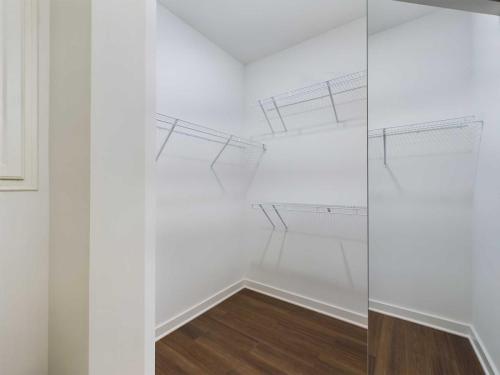 Apartments for rent in Ocala Empty walk-in closet with white walls, wooden floor, and wire shelving units on three sides. Aurora St. Leon Apartments in Ocala 2150 NW 21st Avenue | Ocala, FL 34475 (352) 233-4133