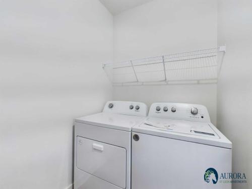 Apartments for rent in Ocala A laundry room with a white washer and dryer below a wire shelf. The Aurora Silicon Apartments logo is in the lower right corner. Aurora St. Leon Apartments in Ocala 2150 NW 21st Avenue | Ocala, FL 34475 (352) 233-4133