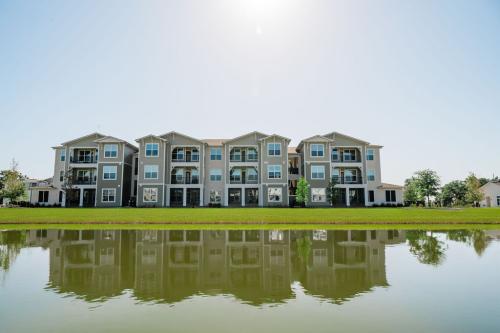 Apartments for rent in Ocala A three-story residential building with multiple balconies is reflected in a pond on a sunny day. Aurora St. Leon Apartments in Ocala 2150 NW 21st Avenue | Ocala, FL 34475 (352) 233-4133