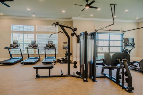 Apartments for rent in Ocala A fitness center with several treadmills, a multi-station strength training machine, an exercise bike, and large windows providing natural light. Aurora St. Leon Apartments in Ocala 2150 NW 21st Avenue | Ocala, FL 34475 (352) 233-4133
