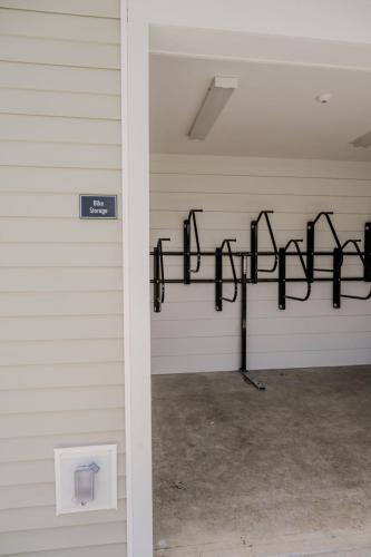 Apartments for rent in Ocala Interior view of a bike storage room with empty wall-mounted racks and visible sign on the exterior wall reading "Bike Storage. Aurora St. Leon Apartments in Ocala 2150 NW 21st Avenue | Ocala, FL 34475 (352) 233-4133