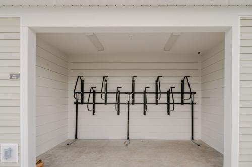 Apartments for rent in Ocala A small, white-walled, open garage containing a vertical metal bike rack mounted on the back wall. Aurora St. Leon Apartments in Ocala 2150 NW 21st Avenue | Ocala, FL 34475 (352) 233-4133